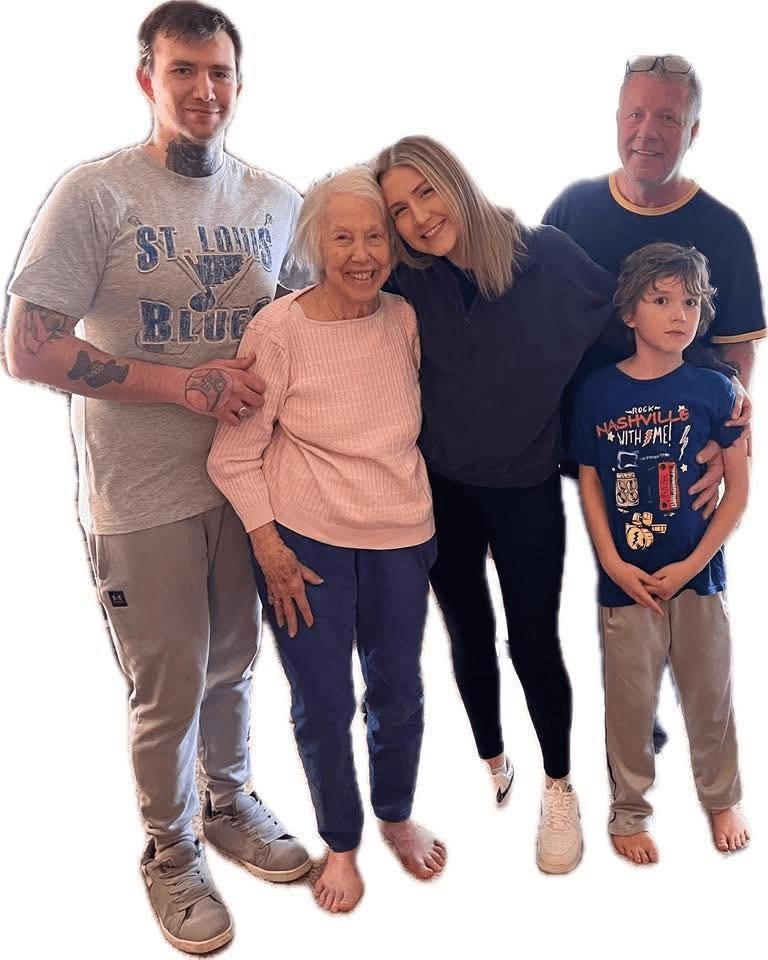 Recent photograph of five people: a tattooed man in a St. Louis Blues shirt, an elderly woman in a pink sweater, a young blond woman, an older man, and a young boy.